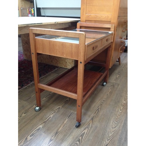 1067 - A mid 20th century teak trolley with mirrored top.