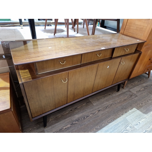 1069 - A vintage G Plan 'Librenza' tola teak and ebonised sideboard, length 149cm.