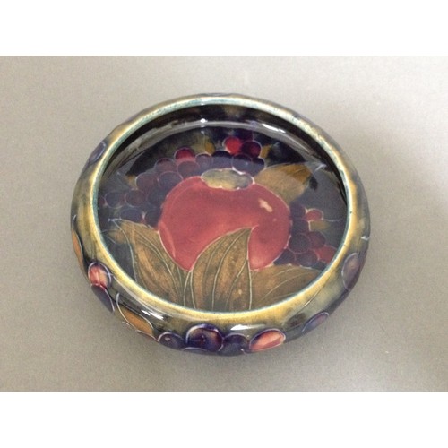 111 - A Moorcroft pottery dish decorated in pomegranite, impressed and painted marks to base, diameter 11c... 