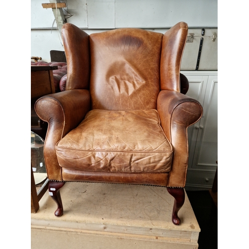 1015 - A Laura Ashley tan leather wingback armchair.