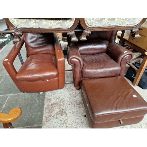 1023 - A leather armchair with matching stool and a vintage leather armchair