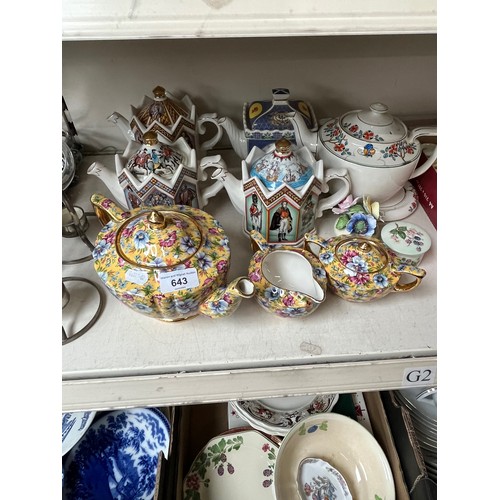 643 - A collection of teapots including Saddller Royal family teapots etc.