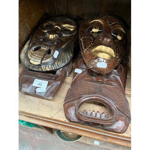 45 - Four carved wooden masks, two Indonesian, two African.