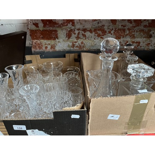 158 - Two boxes of glassware to include 5 decanters, various vases, a jug, drinking glasses, etc.