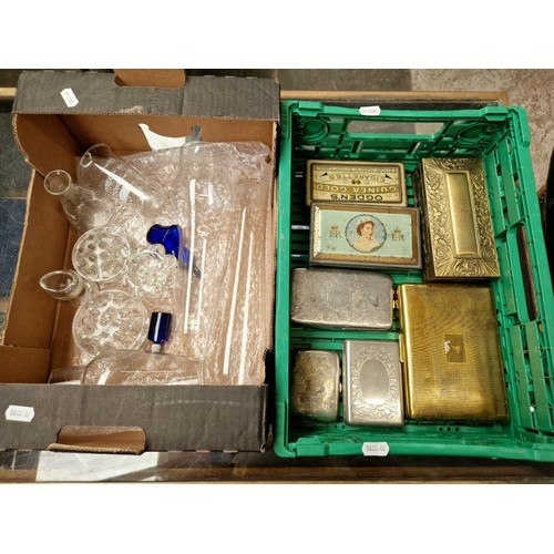 64 - A box of glassware and a box of metal cigarette boxes and tins.