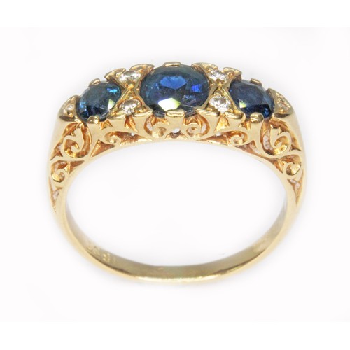 34 - A sapphire and diamond ring, the central stone measuring approx. 5.06mm x 5.20mm x 2.86mm, scroll se... 