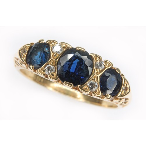 34 - A sapphire and diamond ring, the central stone measuring approx. 5.06mm x 5.20mm x 2.86mm, scroll se... 