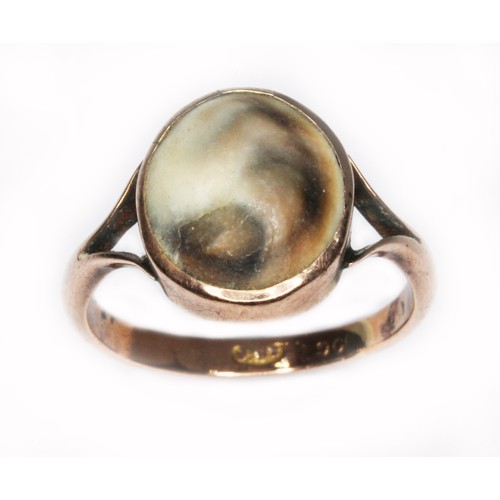 60 - An operculum cabochon ring, maker's mark 'J.Bs', marked '9c', gross wt. 2.9g, size Q.