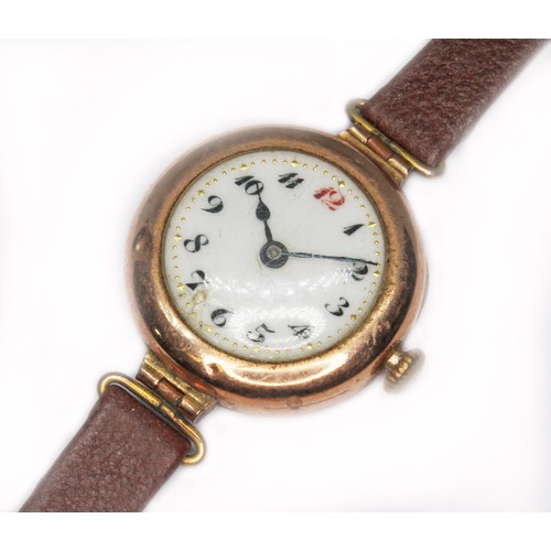 65 - A ladies 9ct gold wristwatch, case diam. 26mm, leather strap.