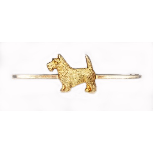 71 - A novelty bar brooch set with a Scot dog, marked '9ct', length 50mm, wt. 2.9g.