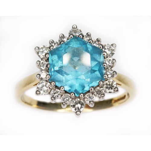 73 - A blue topaz and diamond cluster ring, the central hexagonal cut stone measuring approx. 8mm x 9mm x... 