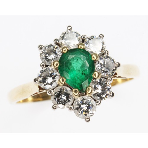 72 - An emerald and diamond cluster ring, the central pear cut stone weighing approx. 0.50cts, surround b... 