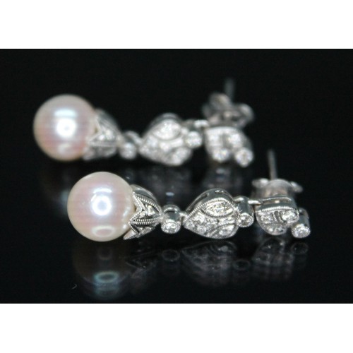 82 - A pair of South Sea cultured pearl and diamond drop earrings, the pearls approx. 8mm in diameter, le... 