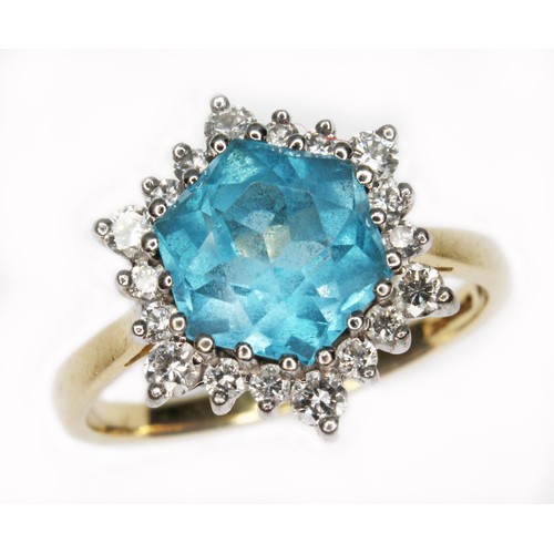 73 - A blue topaz and diamond cluster ring, the central hexagonal cut stone measuring approx. 8mm x 9mm x... 