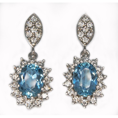 76 - A pair of aquamarine and diamond earrings, each oval mixed cut aquamarine weighing approx. 0.70cts e... 