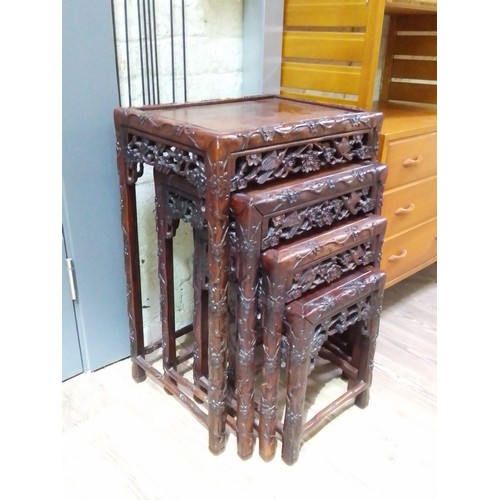 335 - A Chinese carved hardwood nest of four tables, circa 1900, height 71cm.