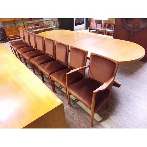 341 - A Gordon Russell D end extending dining table with two extending leaves and eight chairs designed by... 