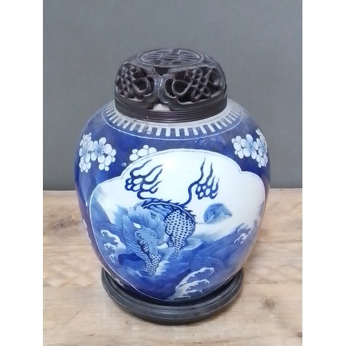 314 - A Chinese blue and white porcelain ginger jar with carved hardwood cover and stand, unmarked, 18th/1... 