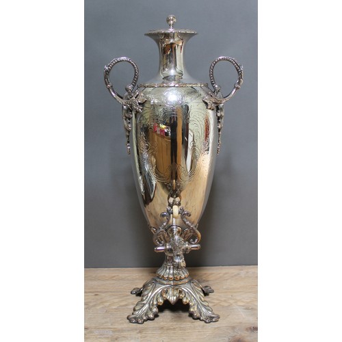 151 - A large silver plated tea urn, twin handled, bright cut engraved ovoid body, acanthus spout with ivo... 