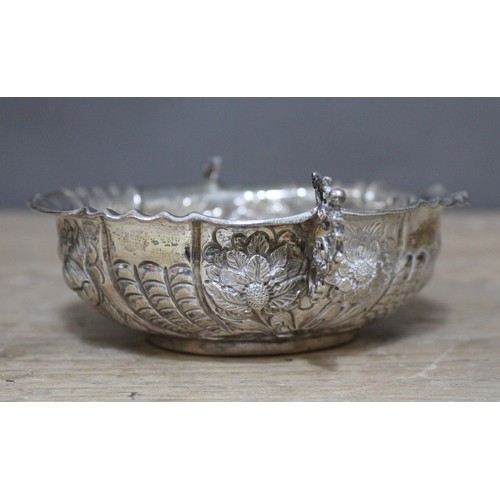 167 - A Victorian embossed twin handled shallow silver dish, William Comyns, London 1886, length 15cm, wt.... 