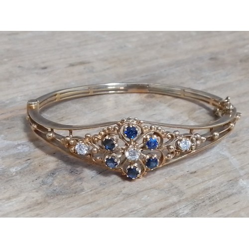 378 - A diamond and sapphire bangle, 9ct gold, sponsor 'HBJ', London 1986, diam. 5.5cm, gross wt. 13g.