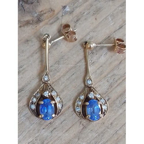 381 - A pair of hallmarked sapphire and diamond earrings, length 31mm, gross wt. 2.8g.