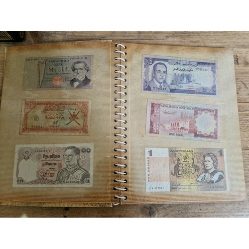 243 - Three folders of assorted world banknotes