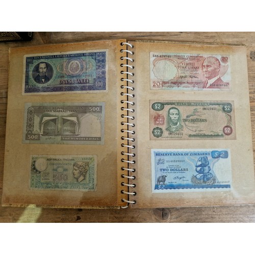 243 - Three folders of assorted world banknotes