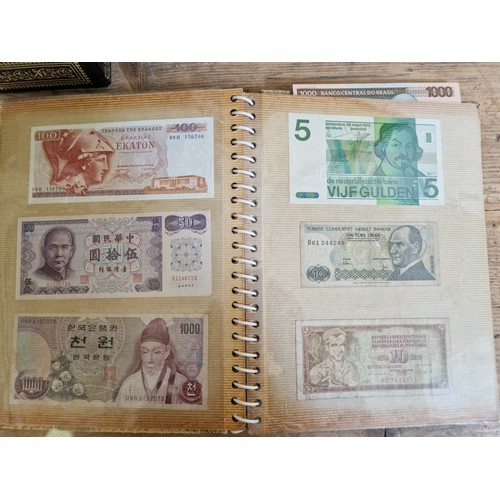 243 - Three folders of assorted world banknotes