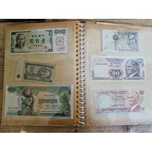 243 - Three folders of assorted world banknotes