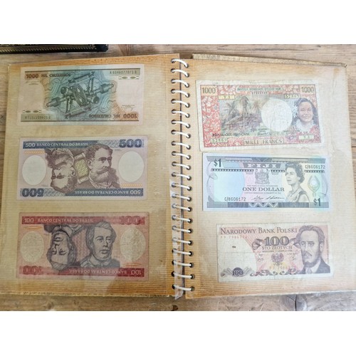 243 - Three folders of assorted world banknotes