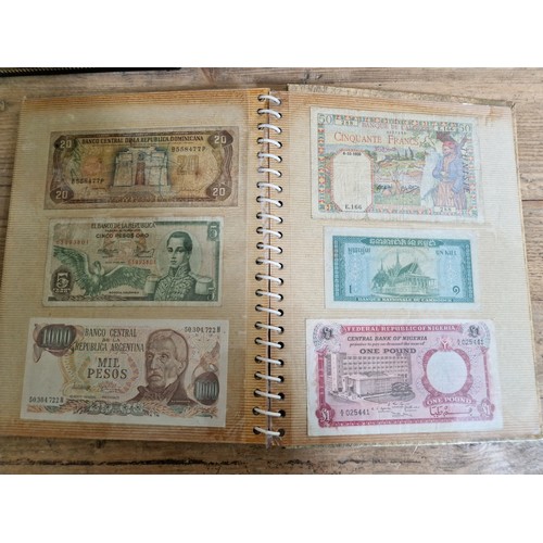 243 - Three folders of assorted world banknotes