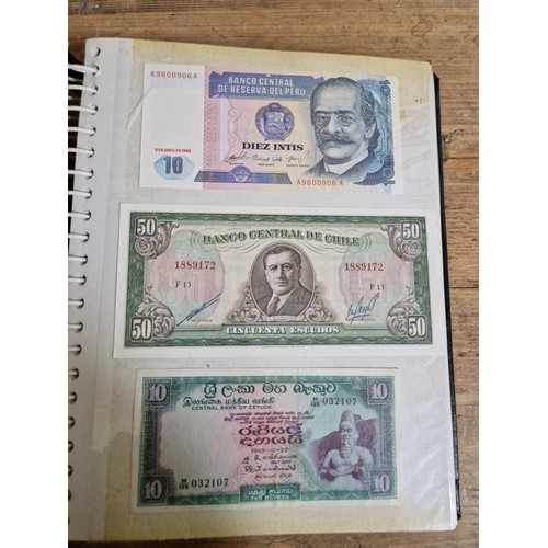 243 - Three folders of assorted world banknotes