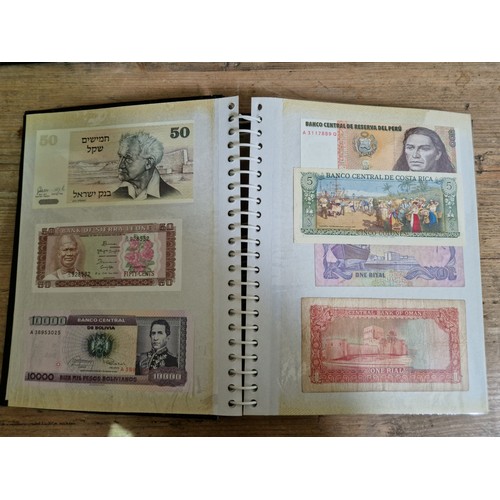 243 - Three folders of assorted world banknotes