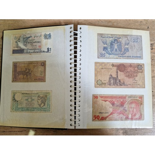 243 - Three folders of assorted world banknotes