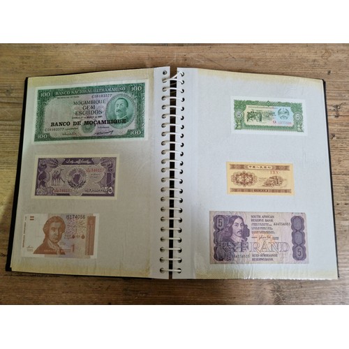 243 - Three folders of assorted world banknotes