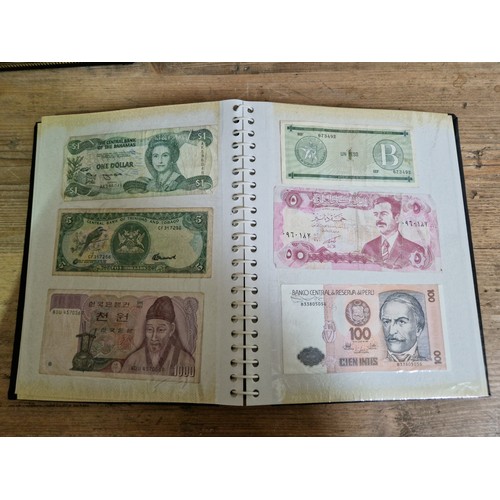 243 - Three folders of assorted world banknotes