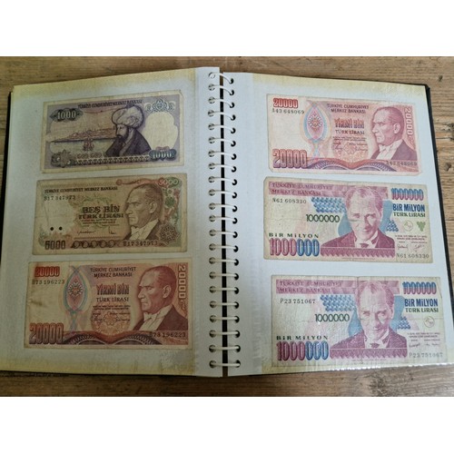 243 - Three folders of assorted world banknotes