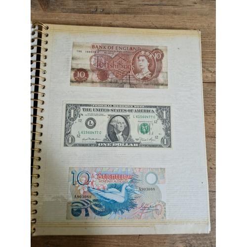 243 - Three folders of assorted world banknotes