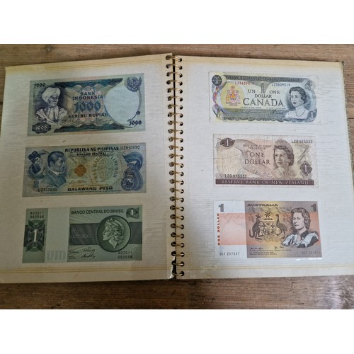 243 - Three folders of assorted world banknotes