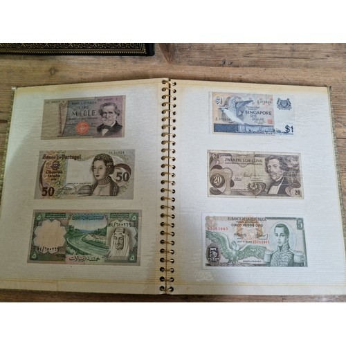 243 - Three folders of assorted world banknotes