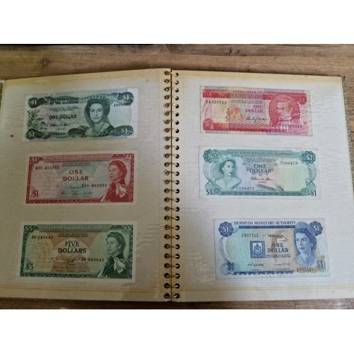 243 - Three folders of assorted world banknotes