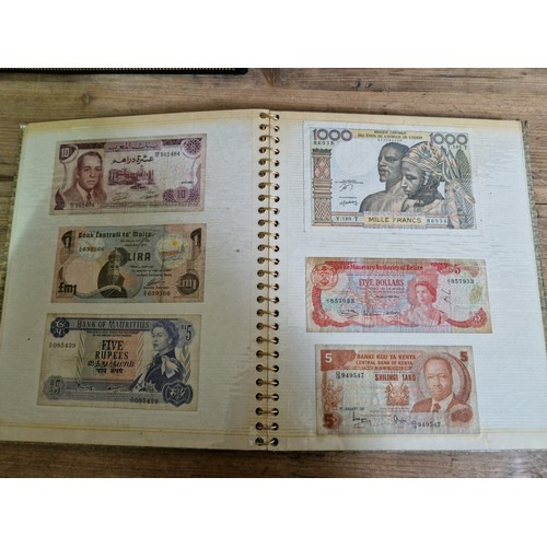 243 - Three folders of assorted world banknotes