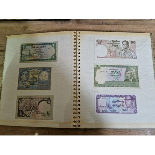 243 - Three folders of assorted world banknotes