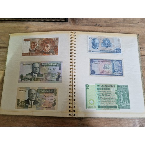 243 - Three folders of assorted world banknotes