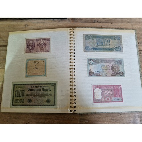 243 - Three folders of assorted world banknotes