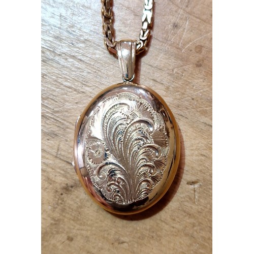 375 - A hallmarked 9ct gold engraved pendant locket on 82cm fancy link chain with 9ct gold import marks, g... 