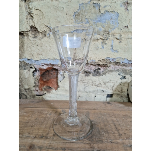 117 - A late 18th century glass with air twist stem and domed foot, height 17.5cm.