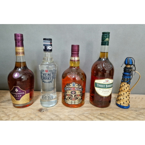 246 - Five bottles of spirits; Chivas Regal 12 year old whiskey, Three Barrels brandy, Courvoisier brandy,... 