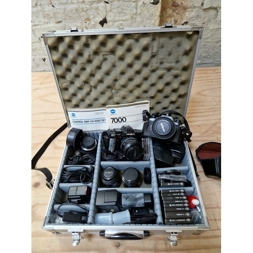 250 - A Nikon camera and a Minolta camera with case and various accessories including lenses etc.